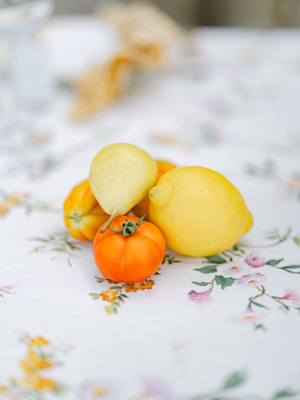 Summer fruit resting on a floral Appolonia tablecloth